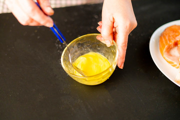 woman beating egg at the kitchen