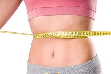 sport, fitness and diet concept, trained belly with measuring tape, health