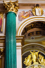 Fragment of rich decorated interior of ancient Saint Isaac's orthodox cathedral, malachite column in russian mosaic style