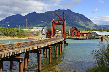 The Iron Rail Bridge of Carcross. Carcross is community in Yukon, Canada, on Bennett Lake and Nares Lake. Carcross is also on the White Pass and Yukon Route railway.