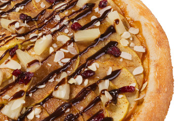 Italian sweet pizza with apples, pineapples and nuts, close-up, on a white background