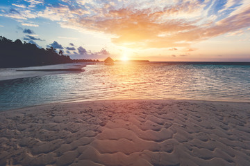 Tropical beach during sunset on an island.