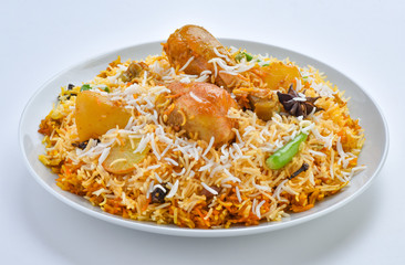 Chicken Biryani, A famous Indian Sub-continent savory rice dish mixed with spicy marinated chicken, spices and flavorful saffron.