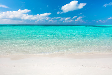Blue ocean and sandy beach on Maldives.