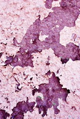 Cracked soft pink paint surface with rusty dark brown details close up, grunge vertical shabby background
