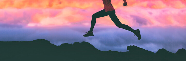 Running legs silhouette of athlete runner woman trail running on mountain rocks against pink sunset...