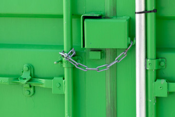 Green storage container locked with chain