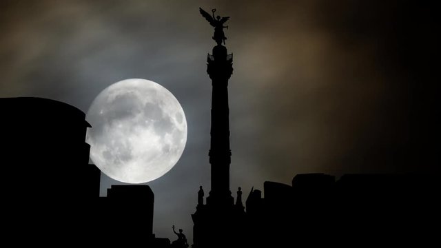 The Angel of Independence ( Monumento a la Independencia ) and Skyline of Mexico City by Night with Full Moon, is a Victory Column on Paseo de la Reforma,  Worlwide Known Symbol of the Capital