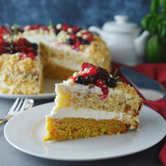 Piece, slice of homemade berry cake. Vegan delicious carrot and orange cake decorated with berries. Healthy dessert. Grey background. Piece of cake.