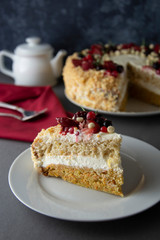 Vegan delicious carrot and orange cake decorated with berries. Healthy dessert. Grey background. Piece of cake.