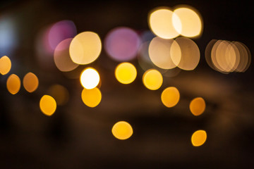 Defocused yellow lanterns on a black background bokeh