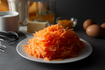 choped carrots for carrot cake, pie or muffins. Ingredients for cooking carrot pie or cake. Cooking dessert.