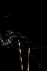 Incense sticks and incense stick smoke on black backgrond