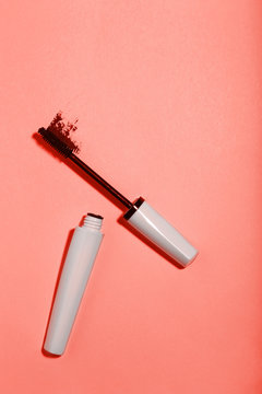 Makeup Mascara On Living Coral Color Background. Minimalism Concept