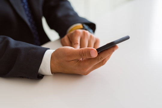 Close up of business man hands using smarpthone