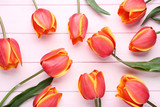 Bouquet of tulips on pink wooden table