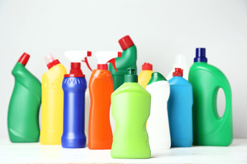 Bottles with detergent on grey background