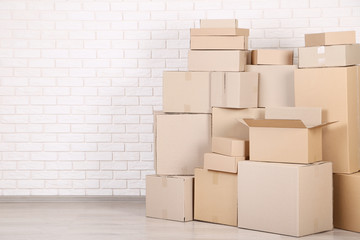 Cardboard boxes on brick wall background