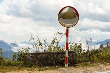 Reflections of the road on traffic mirror for traffic safety. Traffic mirror mountain road, Vietnam