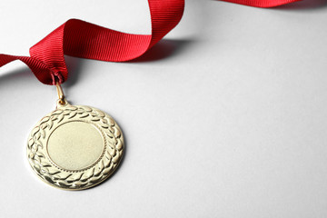 Gold medal with space for design on light background. Victory concept