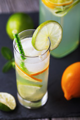 Fresh tonic with lemon and lime in a transparent glass, close-up