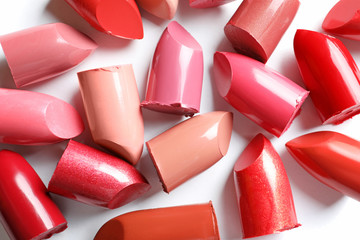 Collection of lipsticks on white background, top view