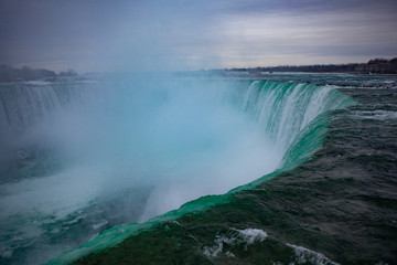 Niagara Falls CANADA - February 23, 2019: Winter frozen idyll at Horseshoe Falls, the Canadian side of Niagara Falls, view showing as well as the upper Niagara River
