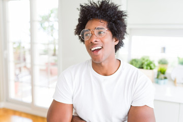 Fototapeta premium African American man wearing glasses smiling looking side and staring away thinking.