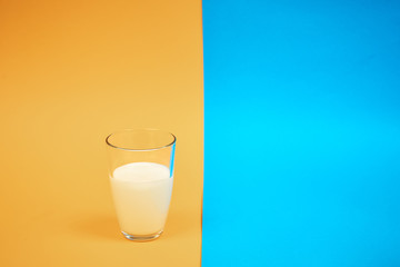glass of milk on a colored background