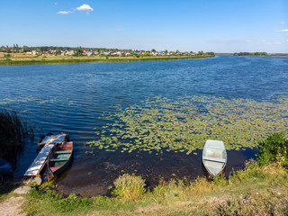 Old boats on river, a province in Russia