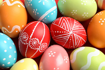 Fototapeta na wymiar Colorful decorated Easter eggs as background, top view