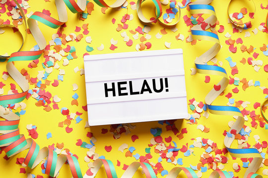 Helau is a traditional german fool's call used during carnival in Germany - flat lay with confetti and streamers