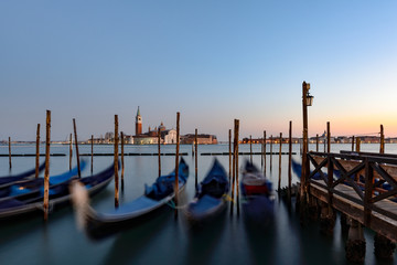 Gondolas in Venice at St Markus Square during sunset-view to San Giorgio Maggiore