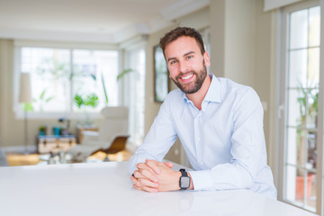 Obraz premium Handsome business man smiling positive at the camera