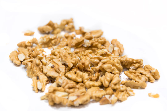 Walnut kernels, close-up macro, isolated on a white background.