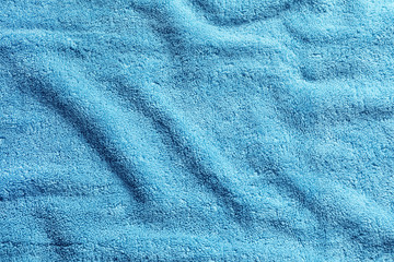 Fototapeta na wymiar Crumpled soft terry towel as background. Space for design