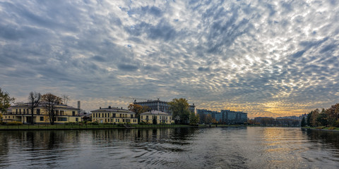 Fototapeta na wymiar General view of Srednyaya (Middle) Nevka river shoreline and embankment architecture. Saint-Petersburg, Russia.