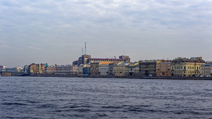 Fototapeta premium Buildings along the Kutuzova embankment of the Neva river and ex-KGB headquarter (Bolshoy Dom) in the background in Saint-Petersburg, Russia.