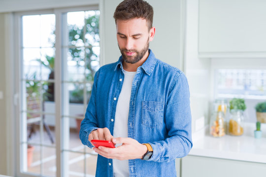 Close up of man hands using smartphone and smiling