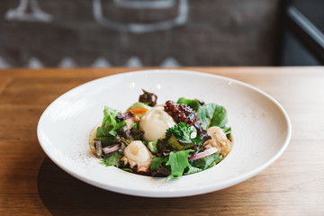 Smoked Galician Octopus with Burrata Cheese, radish, green oak and tomato.