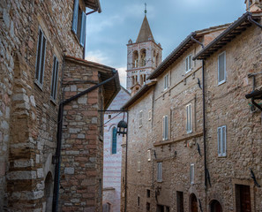 Medieval street in Assisi, and the Basilica di Santa Chiara  at the end. Italy,  Umbria region.