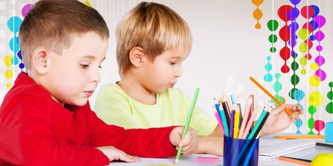 Two little boys studying subject on background