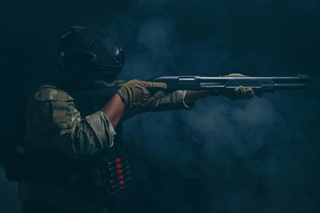 Spec ops police officer in black uniform on a studio background