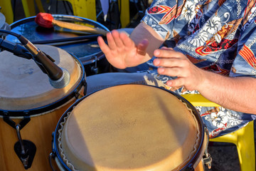 Detail of man playing atabaque during party at the carnival of the city of Belo Horizonte, Minas Gerais