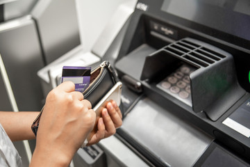 Hand with the credit card at the atm