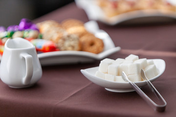 a plate with sugar pieces on the background of the tea table is not a sharp image