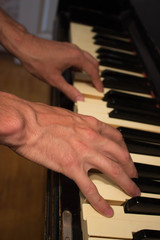 Obraz premium Close up of young boy hands, playing piano. vintage piano