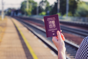 Passport of Czech Republic in female hand. Travel around the World