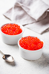 Two bowls with red salmon caviar