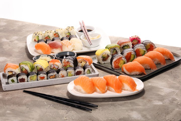 close up of sashimi sushi set with chopsticks and soy - sushi roll with salmon and sushi roll with smoked eel
